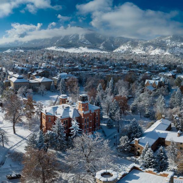 Snowy campus with University Hill neighborhood in the distance