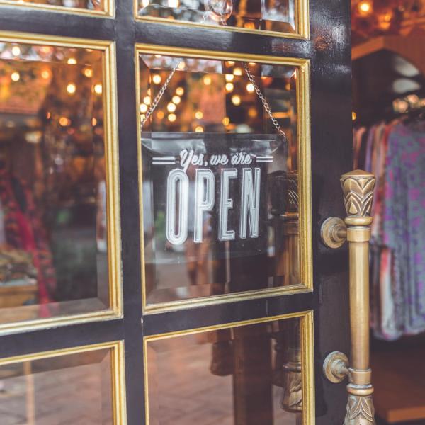 A sign on a door showing a business is open