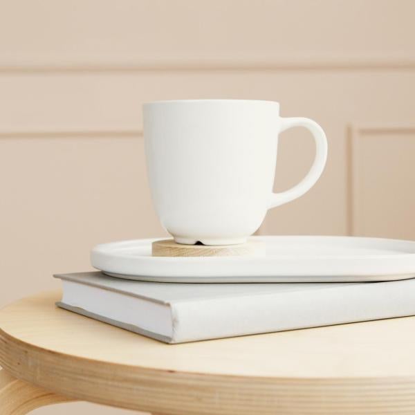 A coffee cup on an armrest