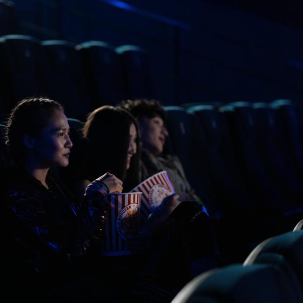 Three people in a movie theater.