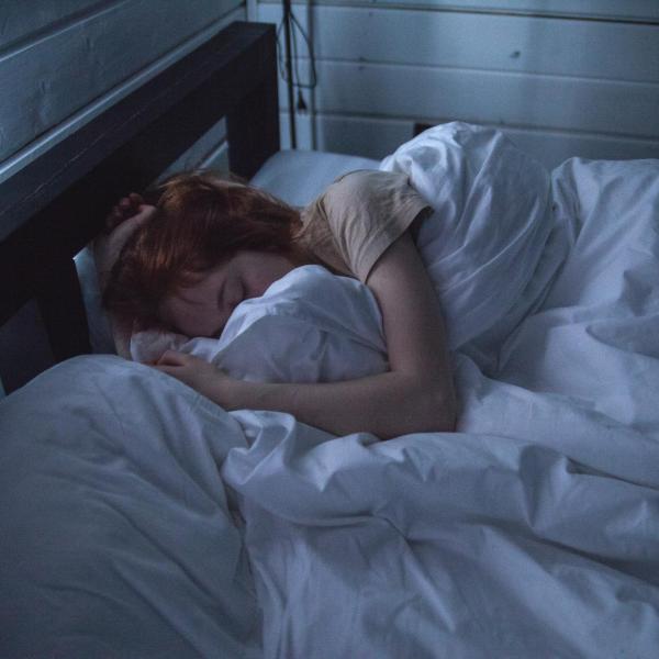 person sleeping in a dark room