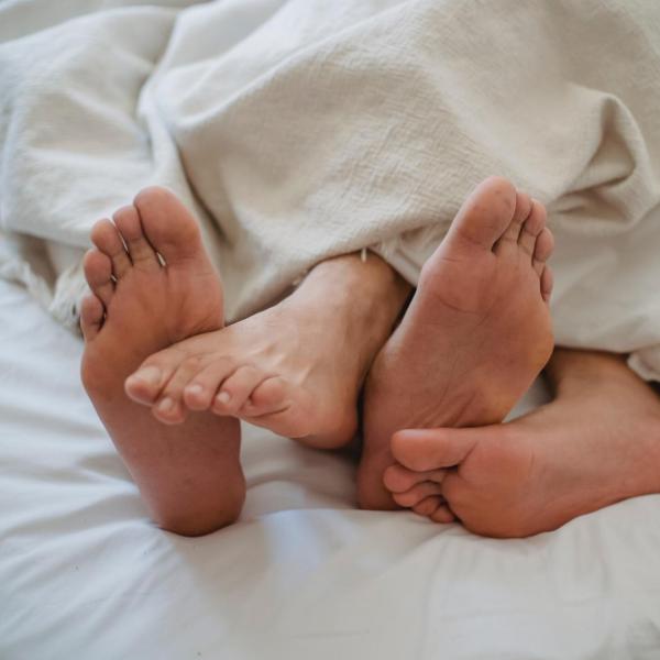 Bare feet sticking out from a blanket