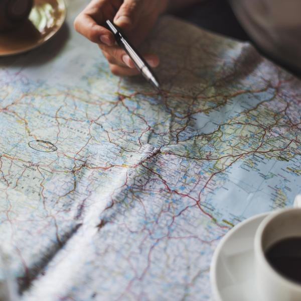 People look at map while drinking coffee