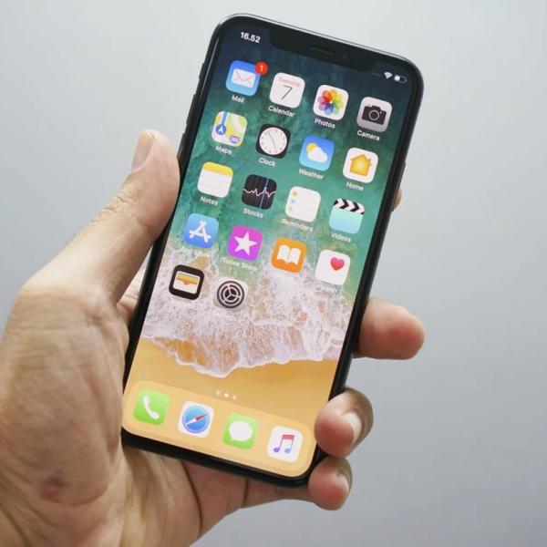 Person holding a mobile phone with apps showing