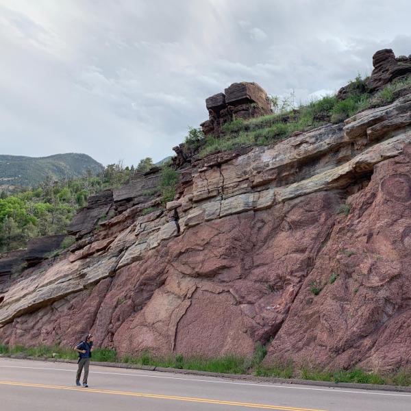 A hiker walks past one site of the Great Unconformity near the town of Manitou Springs, Colorado.