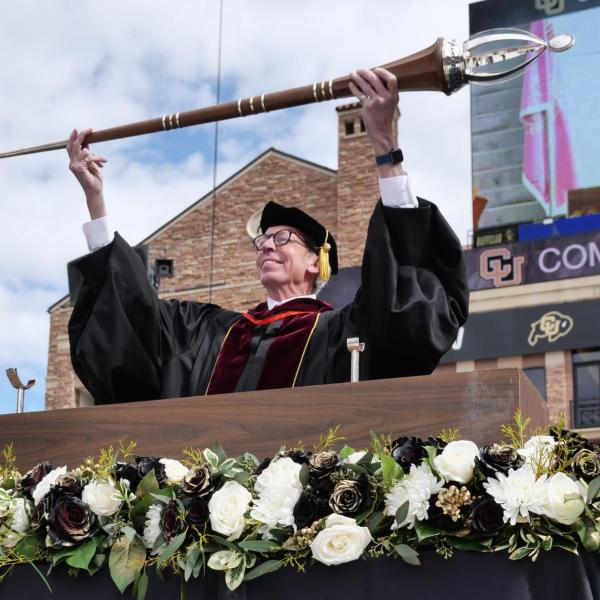 Bud Coleman holds the mace during the 2022 commencement ceremony