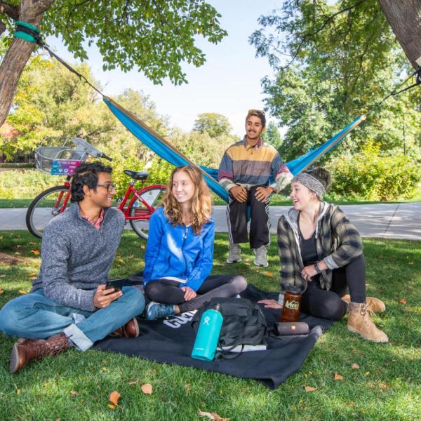 students sitting outside on campus