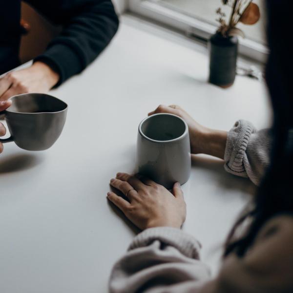 two people talking over coffee