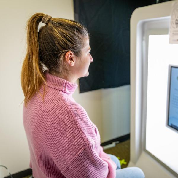 young professional having a headshot taken at a photobooth