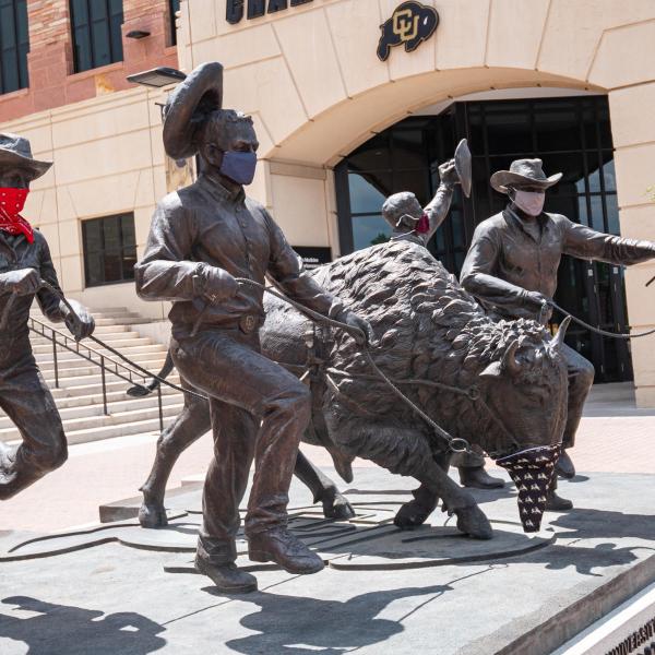 Ralphie running statue with face coverings
