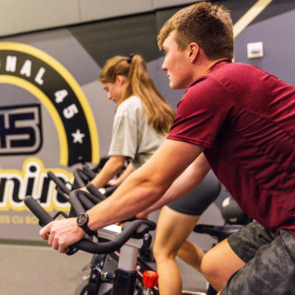 Students riding stationary bikes in a campus rec center