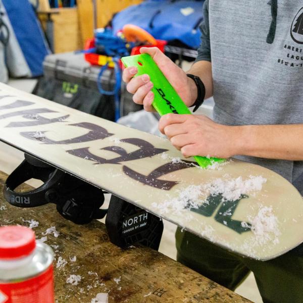someone tuning a snowboard at the Rec Center