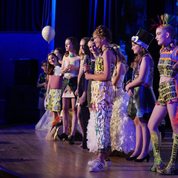 Middle school participants answer questions at Recycled Runway event in 2017