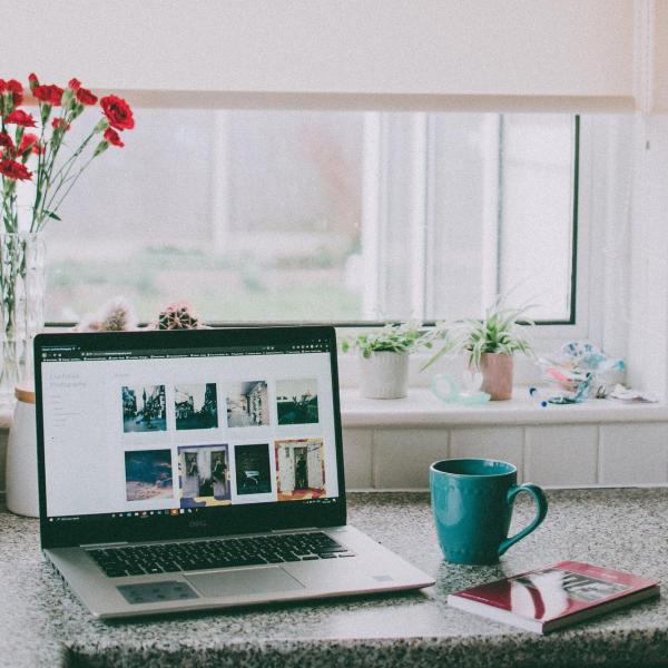 Coffee cup next to computer.