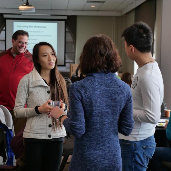 People mingle at a resource expo on the CU Boulder campus.