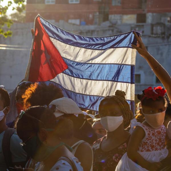People hold up Cuban flag in Havana 2020
