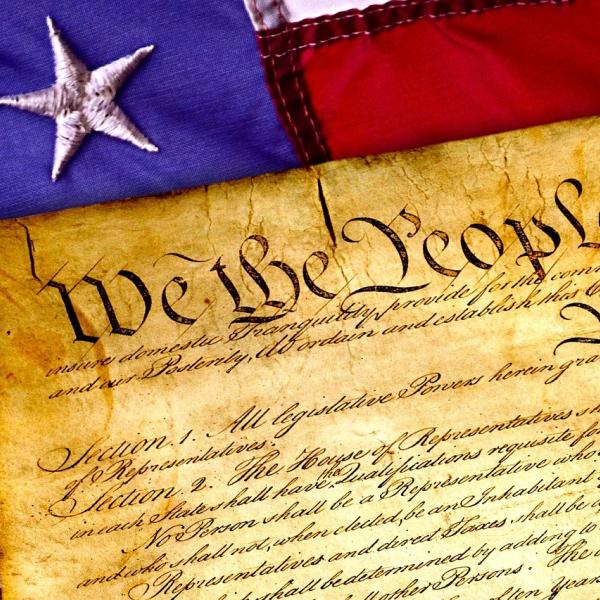 Image of the U.S. constitution and American flag