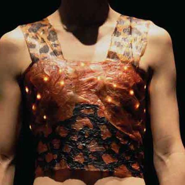 Person wears a shirt made out of kombucha leather with glowing LED lights