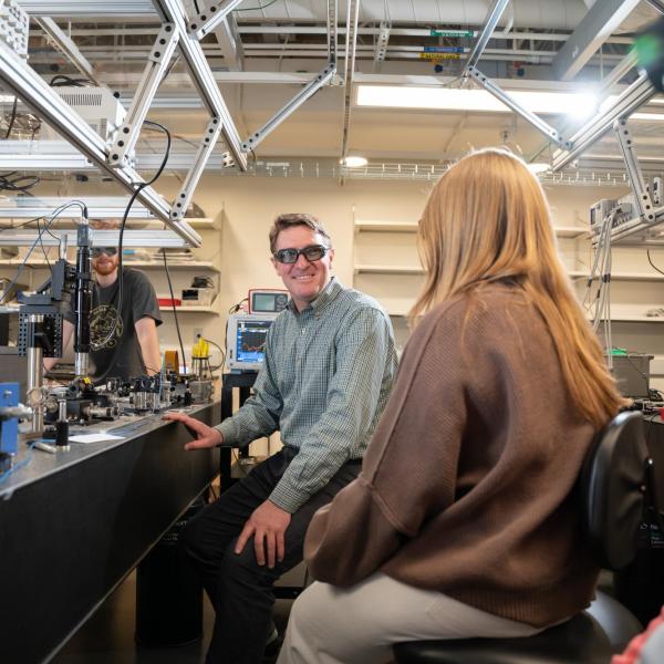 Scott Diddams with his students in the lab
