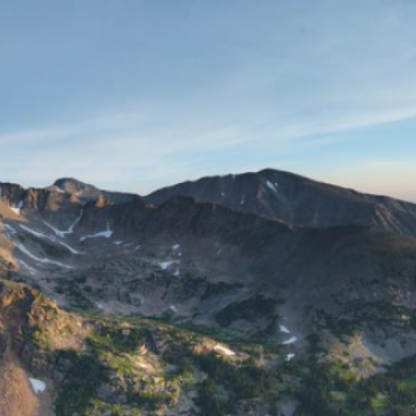 A view of mountain tops with little snow.