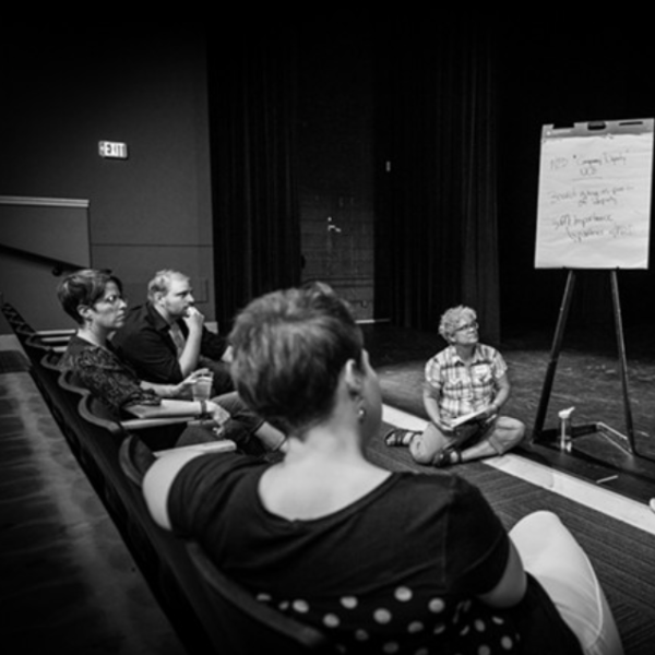 Women discussing the Colorado Theatre Standards