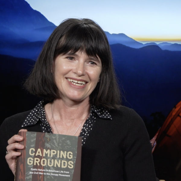 Phoebe Young holding her new book Camping Grounds
