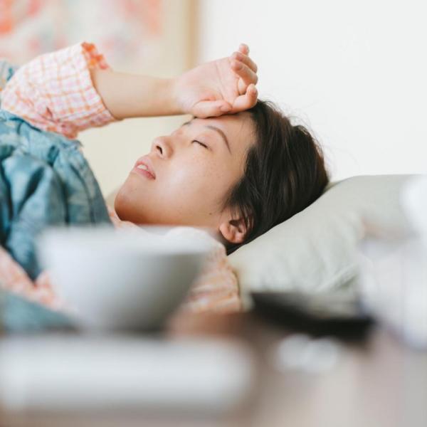 Person lying in bed sick