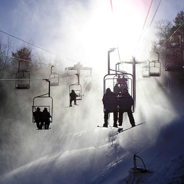 Ski lift takes snow skiers up the mountain