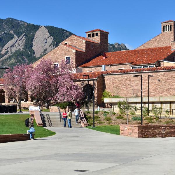 campus community members walking outside of the UMC on a spring day