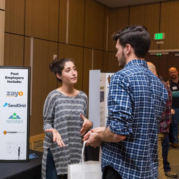 Student speaks with an employer at a startup fair