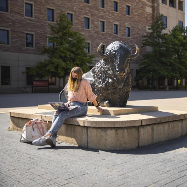 student wearing mask on campus