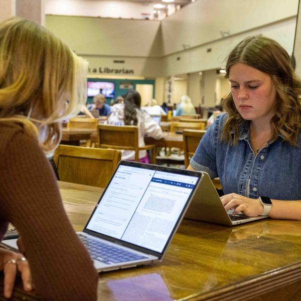 students studying at a table in Norlin Library