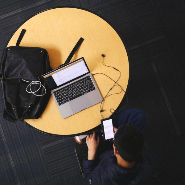 A person uses a table in a study space on campus.