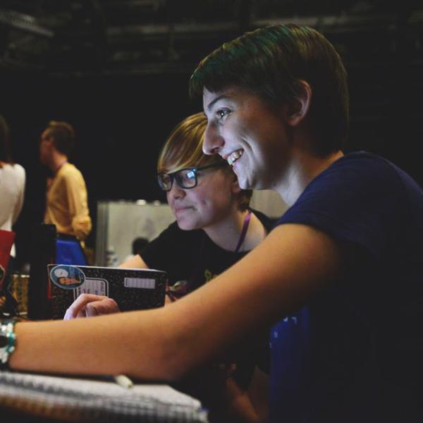 Two women work on computer at T9Hacks event