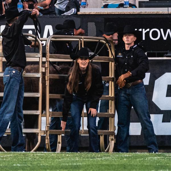 Taylor Stratton, center, getting ready to open the gate for Ralphie VI's inaugural run.