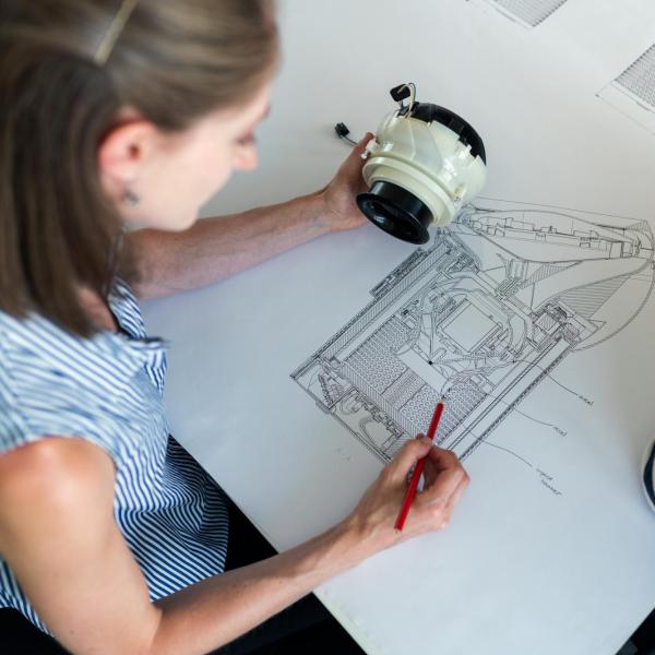 A female noise and vibration engineer develops product designs with a colleague (Image via Unsplash)