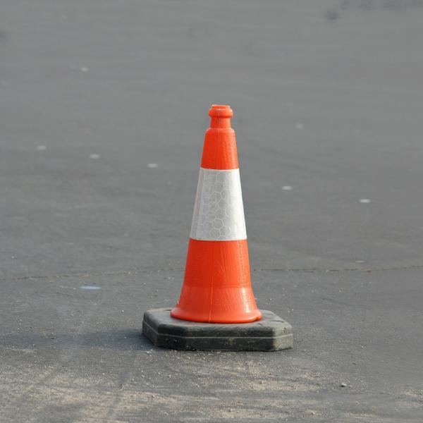 Orange traffic cone on pavement