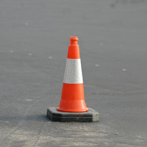 Orange traffic cone on pavement
