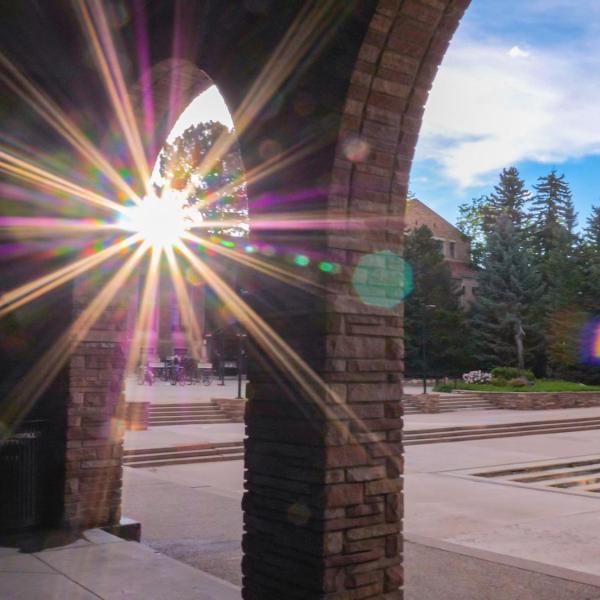 Sun peaks through columns on campus