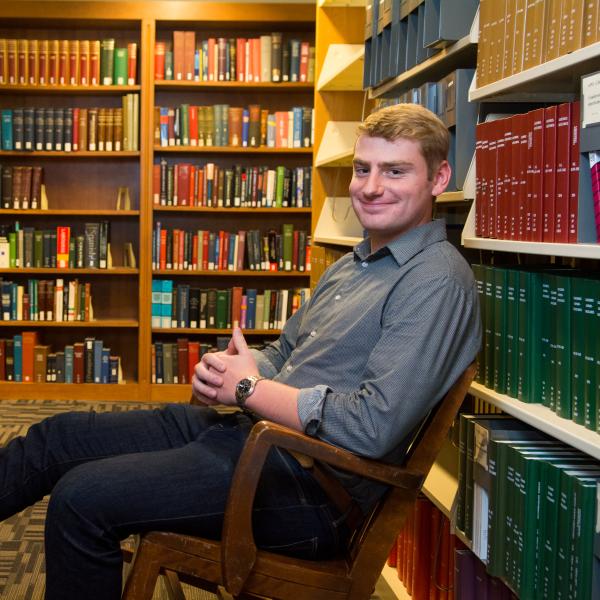 Portrait of Nick Zyzda at the stacks in Norlin Library