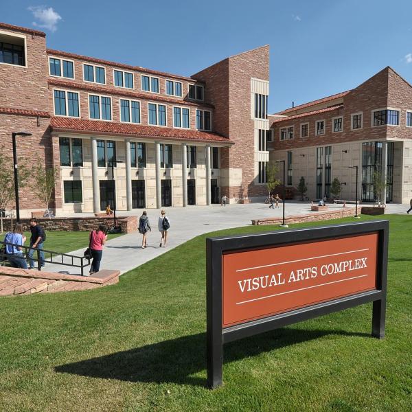 Campus community members walking outside of the Visual Arts Complex