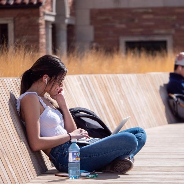 Student studying outside on a warm day
