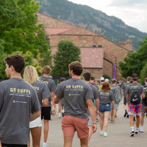 students in matching Buffs shirts walking on campus
