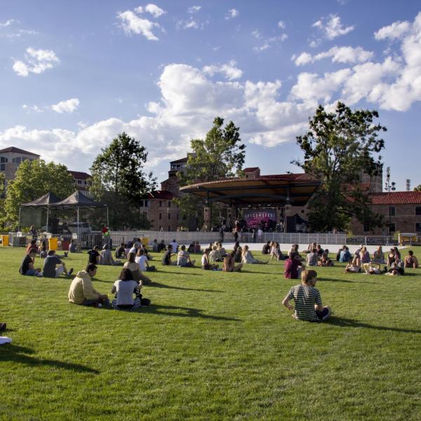 Students sit on Farrand Field lawn to watch a concert