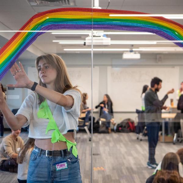 Student helps set up a room for a student workshop