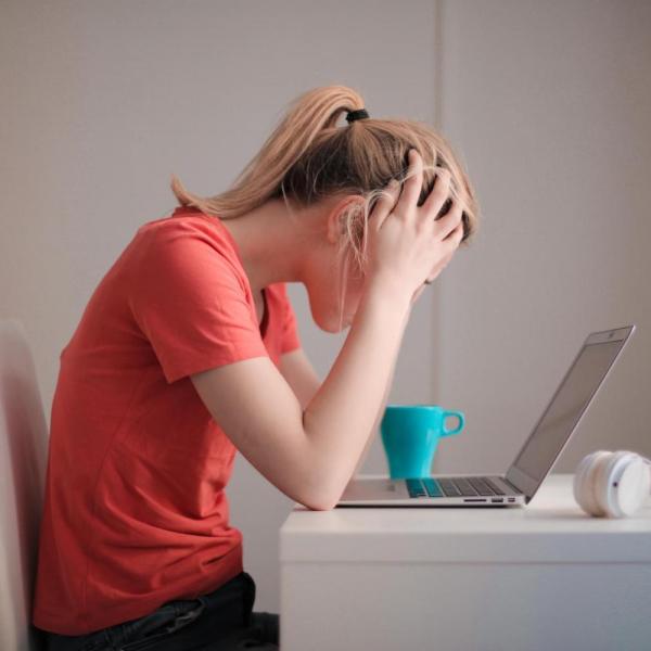 person slumped over computer