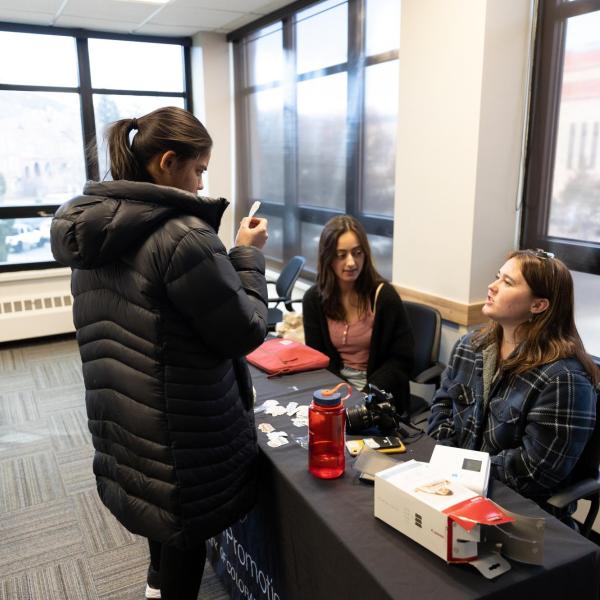A student learning about a resource on campus