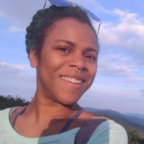 Shaz Zamore taking a selfie on a hike in the mountains.