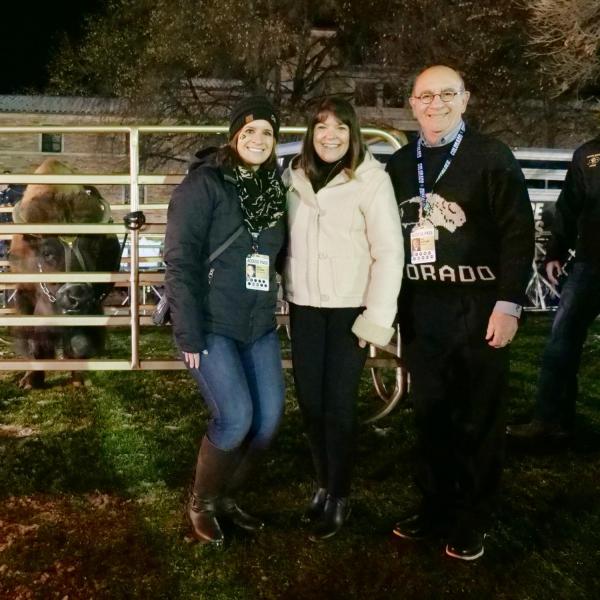 Chancellor Phillip DiStefano, right, poses with his wife, Yvonne, and daughter, Nicole, alongside Ralphie V ahead of Colorado's game against Washington on Saturday, Nov. 23, 2019. (Photo by Glenn Asakawa/University of Colorado)