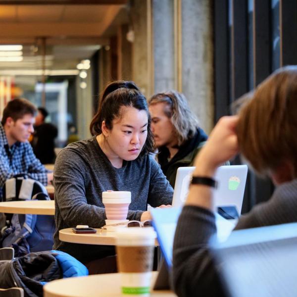 Applied math graduate student Minah Yang works in the lobby of the Engineering Center on the first day of second semester classes. (Photo by Glenn Asakawa/University of Colorado)